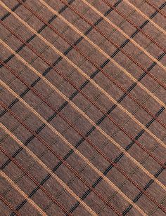 a close up view of a brown and black checkered tie