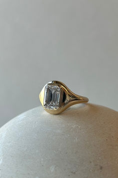 a diamond ring sitting on top of a white vase