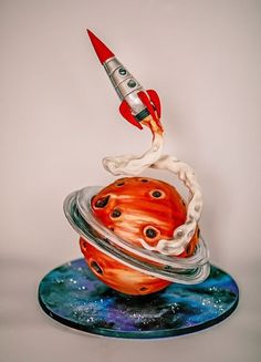 a glass figurine with a rocket on top of it