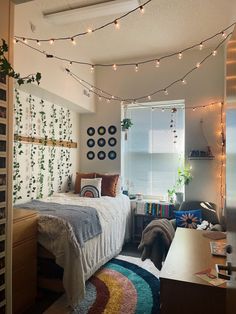 a bedroom with lights strung from the ceiling and a bed in front of a window