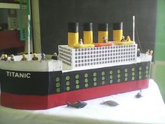 a cake made to look like a cruise ship with yellow and black decorations on it