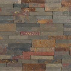 a wall made out of multicolored stone bricks with different colors and sizes on it