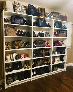 a large white shelf filled with lots of purses and handbags on top of it