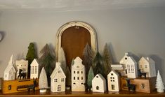 there are many small white houses on the mantle