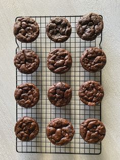 twelve chocolate cookies on a cooling rack ready to be baked in the oven or eaten