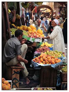 people shopping at an outdoor fruit market