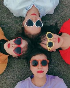 three people laying on the ground wearing sunglasses with their faces covered by fake sun glasses