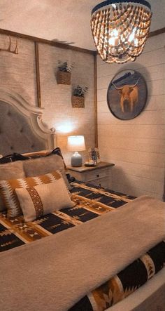 a bed room with a neatly made bed and a chandelier hanging from the ceiling