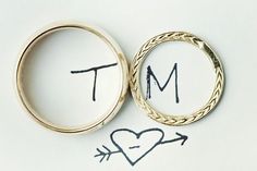 two wedding rings with the word mr and mrs written on them in cursive writing