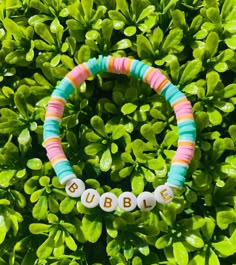 A pink and teal and orange clay bead bracelet with gold letters that is unique but also simple enough to wear with any outfit! *All bracelets are 6.5 - 7 inches, but if custom size is needed, please leave a message or add a note*   You can also mix and match with other bracelets from my shop to create a bracelet stack that suits your style:) All bracelets are.... --------------------------- - Comfortable  - Durable - Stretchy - Colorful - Waterproof ---------------------------- Please contact me at baforsyt11@gmail.com if bracelets arrive damaged or is too small/big. Also feel free to contact me if you would like a custom size, colors, design, or name added to the bracelet:) ( no extra charge )  CARE TIPS ----------------------------------------------------------- - Roll or lightly stretch Casual Pink Name Bracelet For Birthday, Casual Customized Pink Name Bracelet, Trendy Turquoise Stretch Bracelet With Letter Beads, Casual Pink Custom Name Bracelet, Casual Pink Bracelets With Custom Name, Casual Pink Bracelet With Custom Name, Fun Green Stretch Bracelet With Letter Beads, Green Stretch Bracelet With Letter Beads In Fun Style, Cute Pink Name Bracelet With Colorful Beads