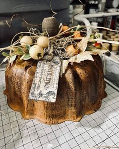 a wooden pumpkin sitting on top of a counter next to some leaves and other things