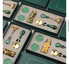 several green boxes with spoons and other items in them