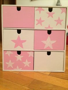 pink and white drawers with stars painted on them