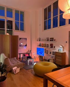 a living room filled with furniture and lots of windows next to a wooden floored floor