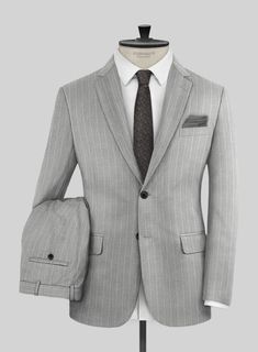 Indulge in understated opulence with the Napolean Genova Stripe Gray Wool Suit – a testament to sartorial finesse. Meticulously crafted from a lavish wool blend fabric, this suit boasts a refined texture in a serene gray hue, complemented by an exquisite stripe design. Its silhouette ensures a graceful cascade, catering to those who seek distinction without conforming to conventional notions of luxury. Whether in the executive boardroom, at upscale evening soirees beneath the stars, or amidst the celebration at weddings, this suit will stand as your distinguished companion.   Look Includes   Napolean Genova Stripe Gray Wool Fabric  Two Button Jacket Style  Notch Lapel  Horn Royal Black Buttons  Single Vent  Three Cuff Buttons  Two Welted Back Pockets on Trousers   Click 'Customize Now' to Executive Boardroom, Beneath The Stars, Grey Tweed Suit, Herringbone Tweed Jacket, Peaky Blinders Suit, Grey Wool Suit, Seersucker Suit, Tweed Pants, Green Suit