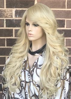 Our Celebrity Inspired Human Hair Wig is so natural looking and Gorgeous! Get ready to get tons and tons of compliments with this lovely unit. The hair is made from high heat resistant fibers and Human hair and can be curled and flat ironed up to 400F. The back part of the wig cap is machine wefted. The wig cap is breathable and comes elasticated to fit every head size and shape up to 22.5 inches in circumference. *Color may appear slightly different than pictured due to your monitor settings. R Wavy Curly Bangs, Bleached Blonde, Blend Wig, Straight Layered Hair, Side Bangs Hairstyles, Curly Bangs, Indian Human Hair, Long Curly Wig, Beautiful Wigs