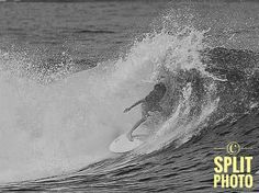 a man riding a wave on top of a surfboard