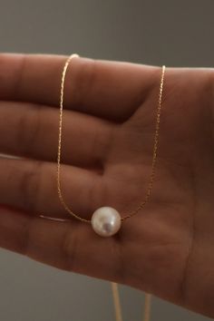 Dainty and minimal, pearl necklace. Designed with the skinniest chain that creates a modern and simple statement. This single necklace is tarnish free and meant to last with the proper love and care. Gold dipped chain and shiny, rounded, pearl. Cheap Pearl Pendant Chain Necklace, Affordable Pearl Pendant Necklace, Cheap Gold Chain Necklace With Pearl Pendant, Cheap Chain Necklace With Pearl Pendant, Cheap Trendy Pearl Chain Jewelry, Luxury Dainty Pearl Necklace As Gift, Cheap Women's Pearl Necklace With Pendant, Cheap Pearl Chain Necklace, Cheap White Jewelry With Delicate Chain