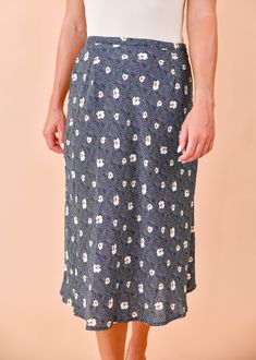 We are loving this fun & flirty midi skirt for any season! A pretty blue and beige floral print dances across this flattering, midi cut, woven fabric as it tumbles from a high waist. Pair this pretty piece with a distressed tee, knit, or a lacy cami for a perfect date-night ensemble! Hidden side zipper Lined 100% Polyester, 100% Rayon (lining) True to size Our model Karin is wearing a size Small