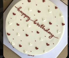 a birthday cake with hearts on it in a box