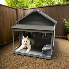 a white dog laying inside of a small house on top of a brown carpeted floor