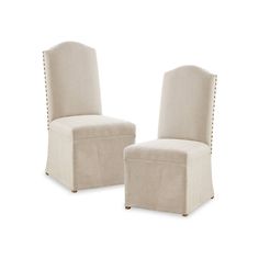 a pair of beige chairs sitting next to each other on top of a white floor