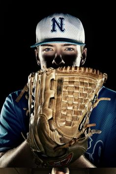 a baseball player wearing a catchers mitt with his face covered by the glove