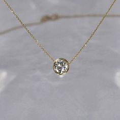 Our most requested necklace for the holidays, featuring a timeless half carat solitaire diamond necklace. Simplistic beauty with unparalleled sophistication. DETAILS: - .50 carat solitaire diamond, G SI+, 5.5 mm - Set in a 14k gold bezel setting - 14k gold cable chain with a lobster clasp closure, 0.5 mm - Custom/larger chains are available upon request - Available in 14k white, yellow or rose gold - Sizes 15 - 20 inches *18k gold and custom lengths available upon request **GIA or EFL certified Diamond Solitaire Necklaces, Bezel Set Diamond Necklace, Fine Jewelry 14k Gold Solitaire Necklace With Brilliant Cut, Minimalist Diamond Solitaire Necklace For Formal Occasions, Minimalist Brilliant Cut Diamond Necklace For Formal Events, Minimalist Brilliant Cut Diamond Necklace For Formal Occasions, Minimalist Single Diamond Necklace For Formal Occasions, Classic 14k Gold Solitaire Necklace, Timeless Yellow Gold Solitaire Necklace With Round Stone