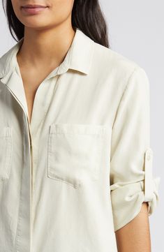 A split back adds soft movement to this slightly oversized button-up shirt cut from a silky, buttery-soft fabric with an eye on sustainability. 25" length Hidden-button placket Spread collar Long sleeves with roll-tab cuffs Chest patch pockets 100% Tencel® lyocell Tencel lyocell is a sustainably produced fiber made with closed-loop processing Machine wash, tumble dry Imported Women's Clothing Versatile Shirt With Shirttail Hem And Buttons, Versatile Shirt With Buttons And Shirttail Hem, Relaxed Fit Blouse With Button Closure For Layering, Effortless Blouse With Button Cuffs And Shirttail Hem, Versatile Rayon Blouse With Shirttail Hem, Blouse With Button Closure And Shirttail Hem, Everyday Blouse With Placket And Shirttail Hem, Summer Tencel Blouse For Workwear, Effortless Spring Shirt With Shirttail Hem