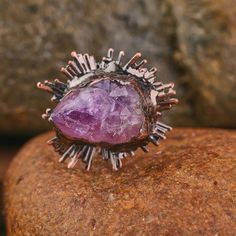 Immerse yourself in the allure of our Vintage Look Bronze Plated Adjustable Ring adorned with Natural Amethyst Crystals. Each ring is a unique masterpiece, with crystal sizes ranging from 21-25x14-16mm, creating a captivating vintage look. With a length of 32x39mm and a weight of 20g, this ring is a perfect blend of sophistication and style. Key Features: Vintage Look Design: The bronze-plated ring exudes a timeless aesthetic, reminiscent of vintage elegance. Natural Amethyst Crystals: Adorn you Spiritual Amethyst Crystal Ring With Gemstone, Mystical Amethyst Gemstone Rings, Spiritual Purple Crystal Ring, Large Stone Amethyst Ring Spiritual Style, Mystical Amethyst Ring As A Gift, Spiritual Amethyst Ring With Large Stone For Gift, Spiritual Amethyst Ring With Large Stone, Spiritual Amethyst Crystal Ring With Natural Stones, Large Stone Spiritual Amethyst Ring