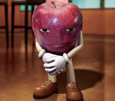 an apple sitting on top of a wooden floor