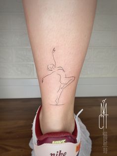 a woman's foot with a small tattoo on the lower part of her leg