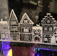 a window display with paper cut houses on it