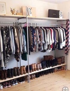 an organized closet with lots of clothes and shoes