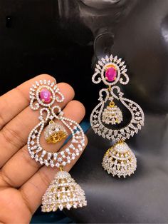 These Chandbali Long Jhumka Earrings offer impeccable style, featuring a unique Indian design with sparkling CZ stone accents, perfect for the next Bollywood or Indian-Pakistani-style party. Festive Heavy American Diamond Jhumkas, Festive Heavy Ruby Jhumkas, Festive Ornate Dangle Jhumkas, Luxury Traditional Ruby Jhumkas, Festive Red Ruby Jhumkas, Long Jhumka Earrings, South Indian Style, Pakistani Style, Indian Bollywood