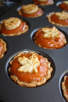 there are many cupcakes in the muffin tin with toppings on them