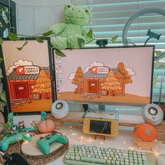 two computer monitors sitting on top of a desk next to a keyboard and monitor screen