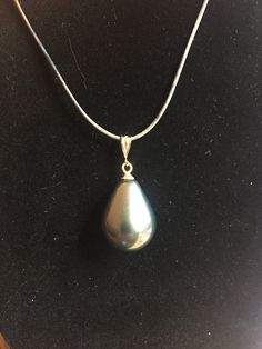 Dark gray, large mother of pearl drop drop (ca 26 mm), set onto a sterling silver dangle mounting, gently swaying from a sterling silver chain complementing the impressive pendant. Wear it as short or as long as you want - just slide the pendant further up or down the chain. Perfect to liven up your fall outfit or for a night out any time of the year. It also makes for a good Valentine's present for your significant other. Gold filled bail or sterling silver. Pair with a sterling silver or gold filled chain, or even a leather cord necklace. Silver Long Drop Necklace With Pearl, Drop Pearl Pendant Necklace, Teardrop Pearl Pendant Necklace, Silver Teardrop Drop Necklace With Pearl Pendant, Silver Teardrop Drop Necklace With Pearl Charm, Sterling Silver Teardrop Pearl Necklace, Silver Teardrop Pearl Pendant Necklace, Silver Drop Pearl Necklace With Pendant, Elegant Gray Pendant Jewelry