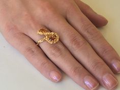 Rare Vintage 14kt Gold Brutalist Ring With Two Citrine Stones. Unique brutalist twist figure eight dome with two oval seated orange stones. Make a statement with this unique chunky piece of jewelry. Markings: SECO 14k Measurements: Ring Size 6, Stones- 5.4mm each Total Weight: 5.26 grams Condition: Great Vintage condition, ready to wear. Please review the photos for visual detail and let me know if you have any further questions prior to purchase. I don't offer returns or exchanges. USA sales on Unique Gold Rings With Birthstone, Unique Yellow Gold Ring With Birthstone, Unique Yellow Gold Birthstone Ring, Unique Yellow Gold Ruby Ring, Unique Gold Ruby Ring For Anniversary, Gold Amethyst Birthstone Ring Heirloom Style, Gold Amethyst Hallmarked Promise Ring, Gold Amethyst Ring In 14k Gold, Gold Amethyst Promise Ring Hallmarked