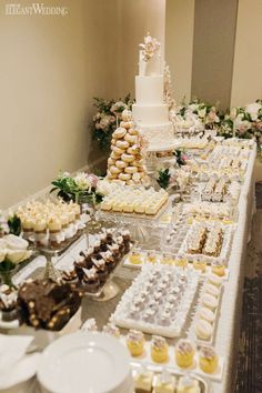 a table filled with lots of different types of desserts and pastries on it