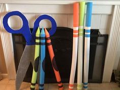 there are several different colored scissors next to each other on the counter in front of a fireplace