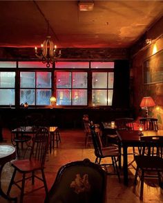 a dimly lit restaurant with tables and chairs