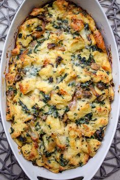 a casserole dish with spinach and cheese in it on a gray surface