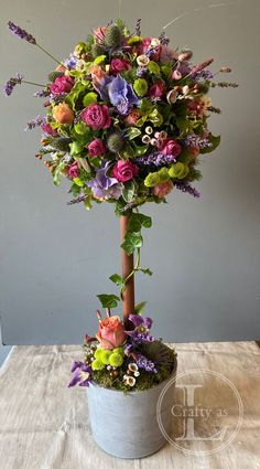 a potted plant with flowers and greenery in it