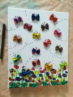 an art project made out of paper with butterflies on it and flowers in the middle