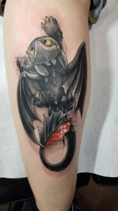 a black and grey tattoo with a dragon on it's leg, holding an umbrella