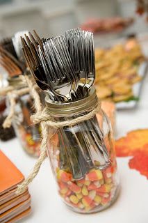 a jar filled with lots of silverware sitting on top of a table