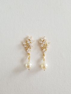 "Gorgeous sparkly cubic zirconia wedding earrings for the bride. Handcrafted with Swarovski pearls and high quality cubic zirconias. For pierced ears only. I do have other types of pearls available such as freshwater pearls and shell pearls that are in different shapes & sizes. Please contact for other options. ♥ SIZE: 2 1/8\" long x 3/4\" wide ♥ COLORS: Silver, Gold, Rose Gold ♥ PRODUCTION TIME: Ready to ship out in 1-2 business days ♥ IMPORTANT: Please be sure to read my policy section for Pearl-embellished Cubic Zirconia Drop Earrings, Gold Diamond Earrings With Pearl Drop For Wedding, Pearl Embellished Cubic Zirconia Wedding Earrings, Wedding Pearl Earrings With Sparkling Cubic Zirconia, Pearl White Bridal Earrings With Pearl Drop, Delicate Pearl Drop Earrings With Cubic Zirconia, Cubic Zirconia Pearl Drop Earrings, Wedding Pearl Earrings With Sparkling Stones, Pearl White Cubic Zirconia Earrings For Wedding