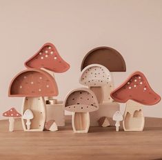 a group of wooden mushrooms sitting on top of a table next to eachother