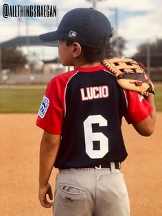 a young boy wearing a catchers mitt on top of a baseball field,